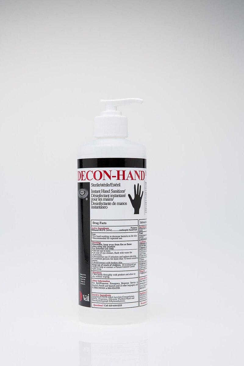 DECON-HAND sanitizer bottle shown with attachable pump dispenser secured on the bottle.