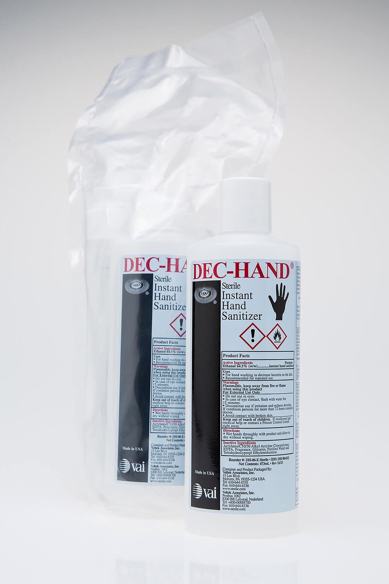 Two DECON-HAND sanitizer bottles displayed side by side, one with flip-top cap and one with pump dispenser.