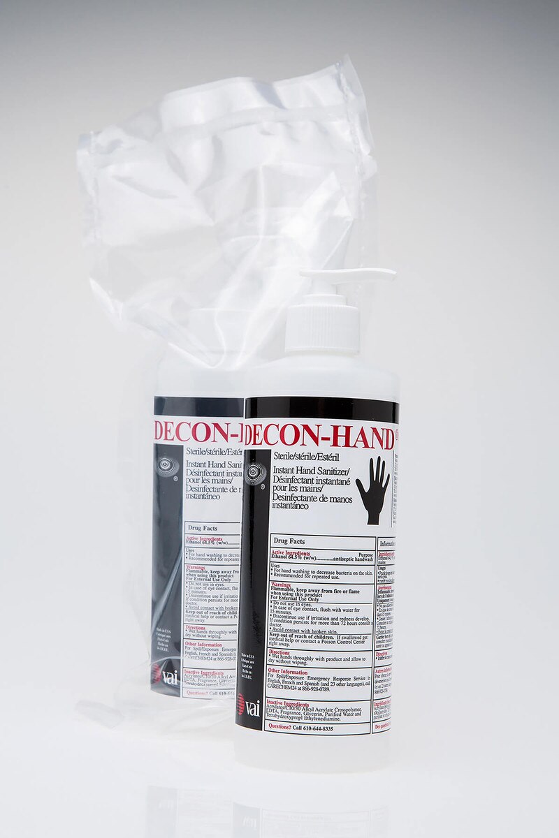 Packaged DECON-HAND sanitizer bottle visible inside protective packaging.