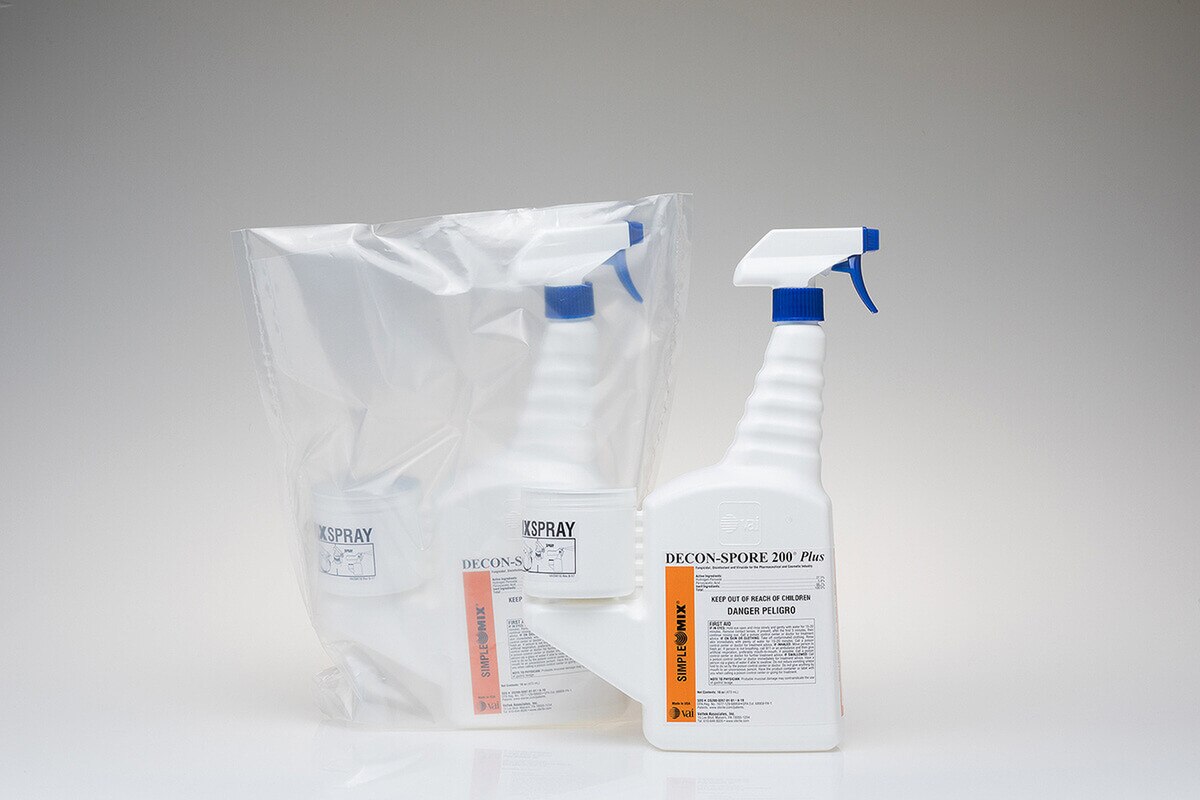 Side-by-side DECON-SPORE 200 Plus 3% trigger spray bottles showing one sealed in sterile packaging and one unbagged with SimpleMix reservoir attached