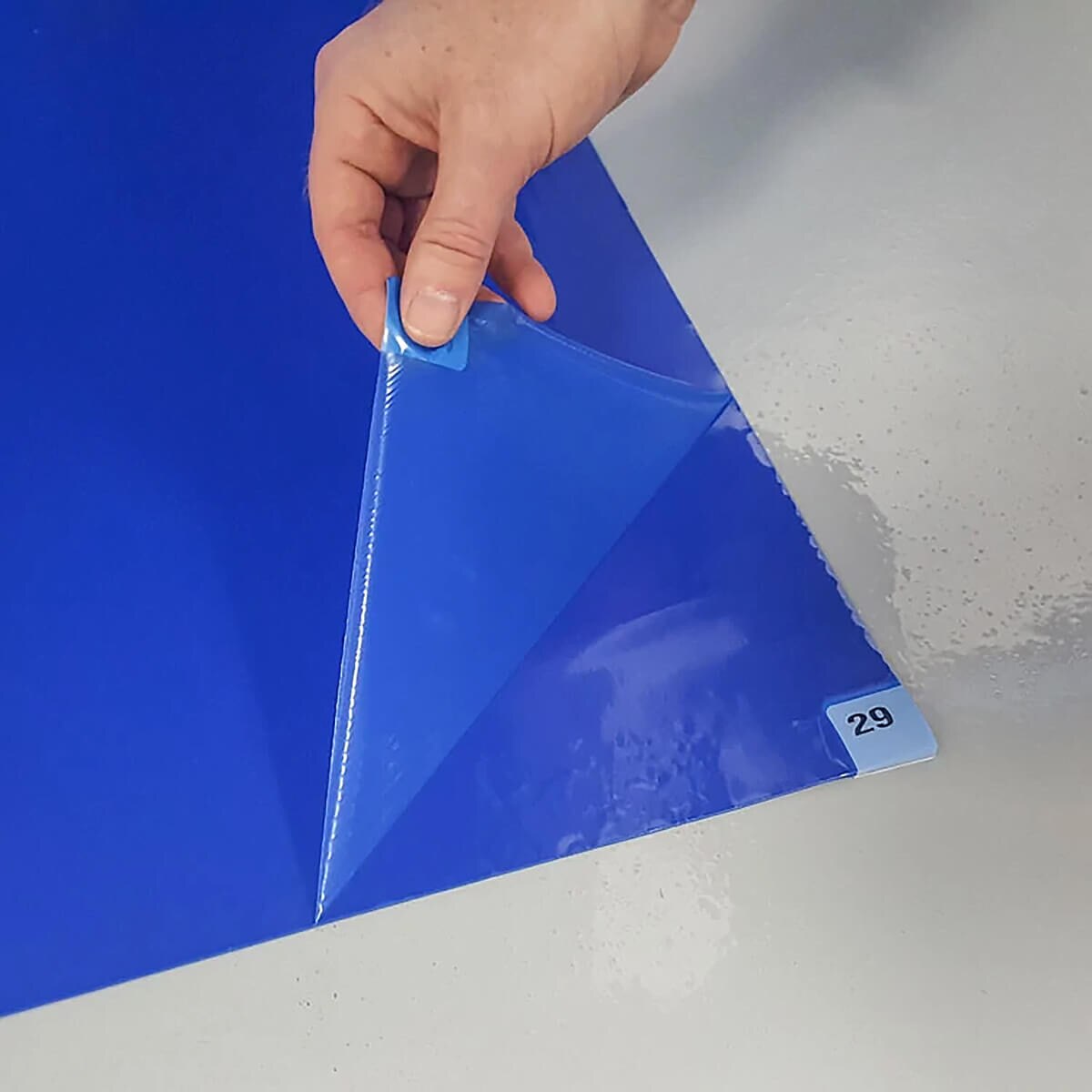 Tacky Traxx, Blue Tacky Mat, Adhesive Back, 18x36 showing peel off adhesive